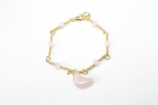 Copper Gold Plated bracelet with pink semi-precious stones on a light gray background