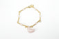 Copper Gold Plated bracelet with pink semi-precious stones on a light gray background